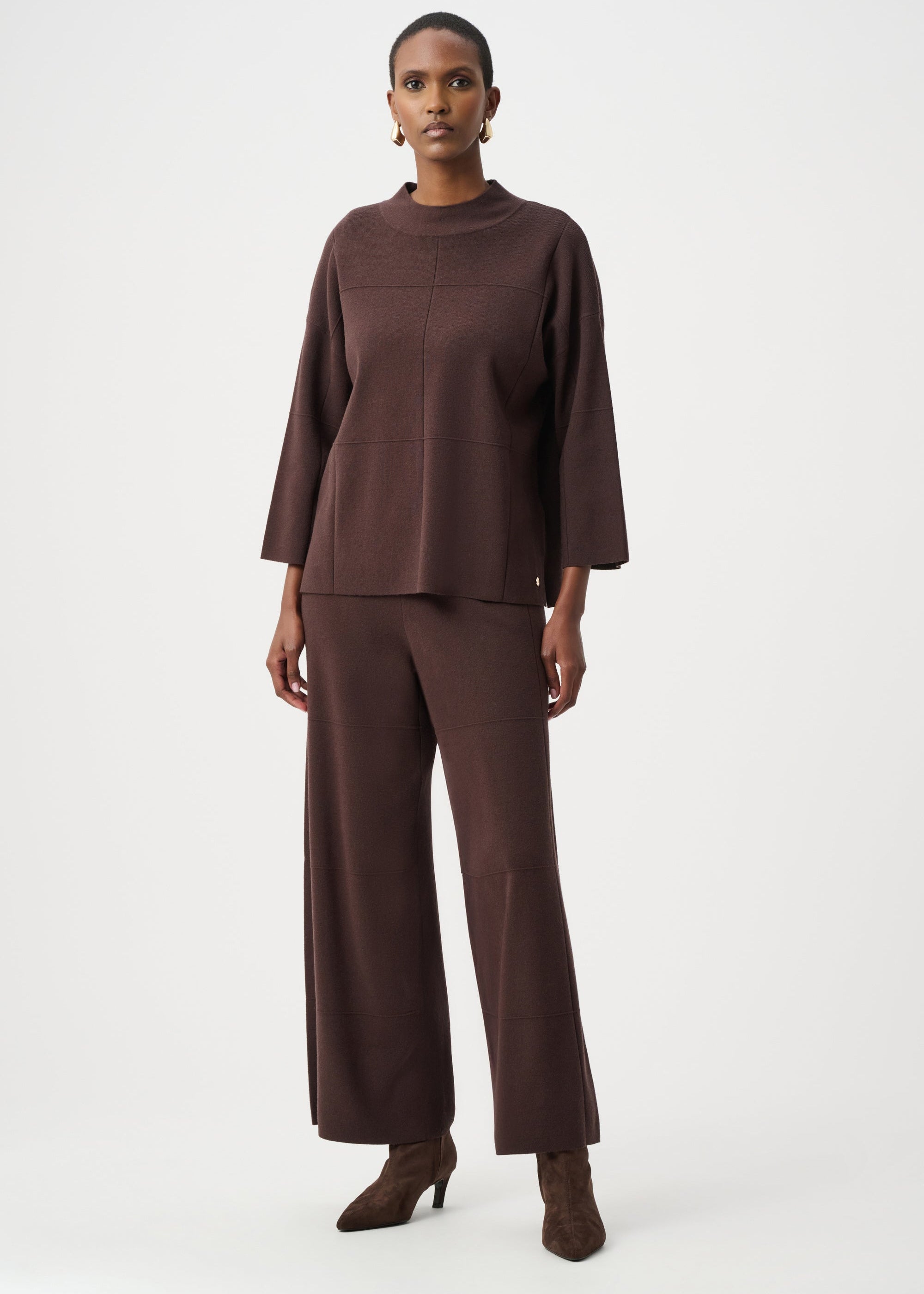 Woman wearing a brown outfit on a white background