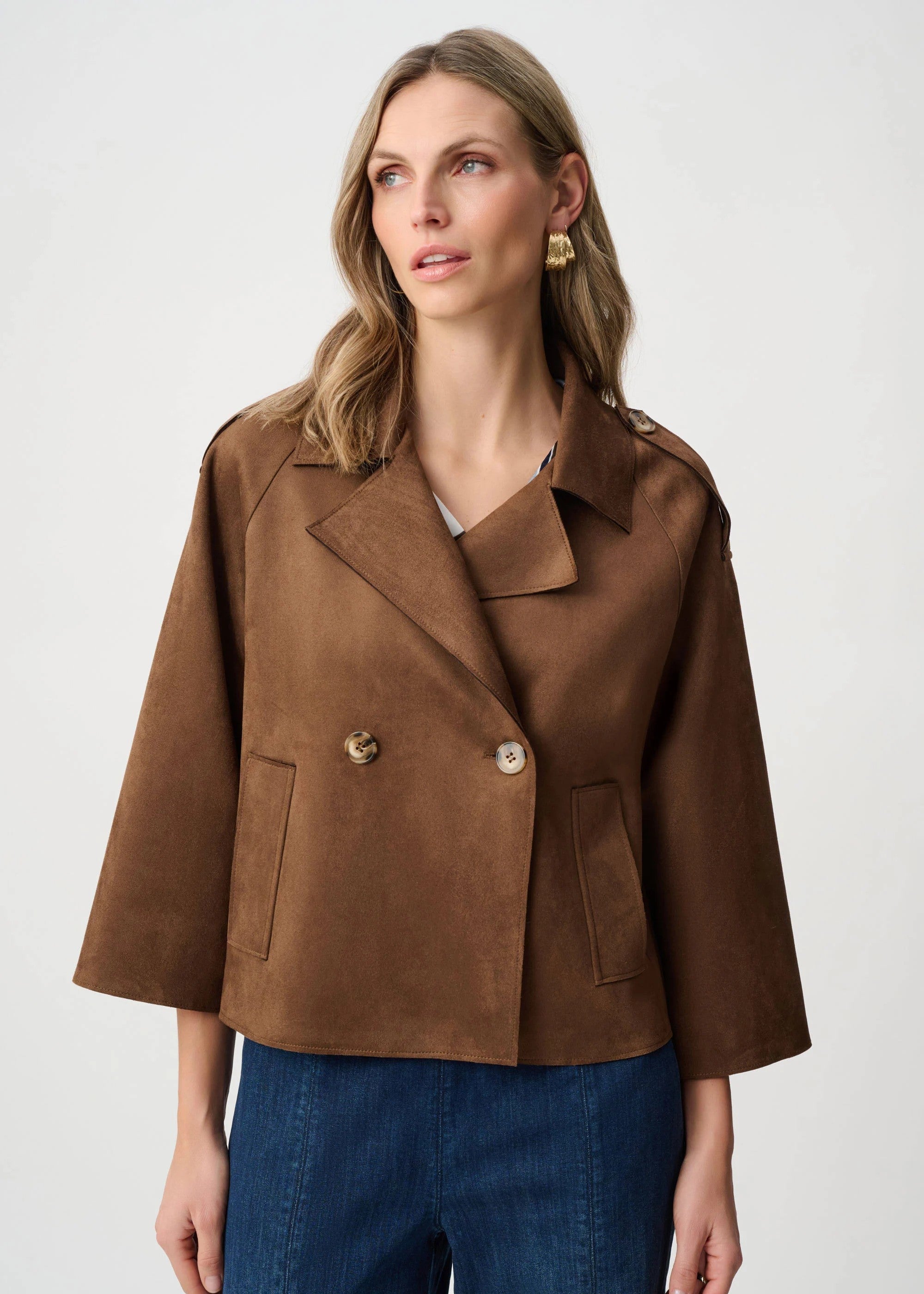 Woman wearing a brown jacket with a white background
