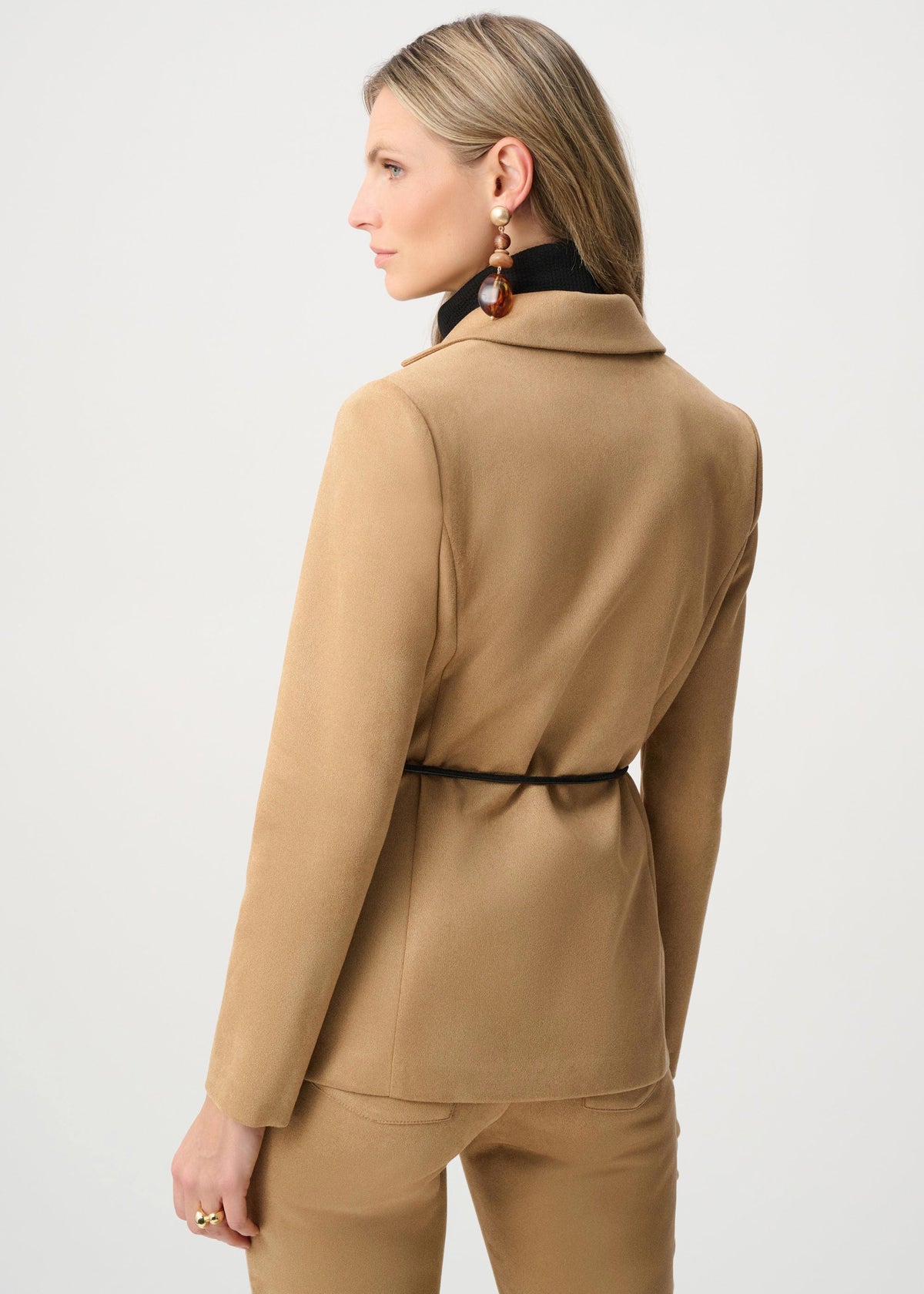 Woman wearing a beige suit on a white background