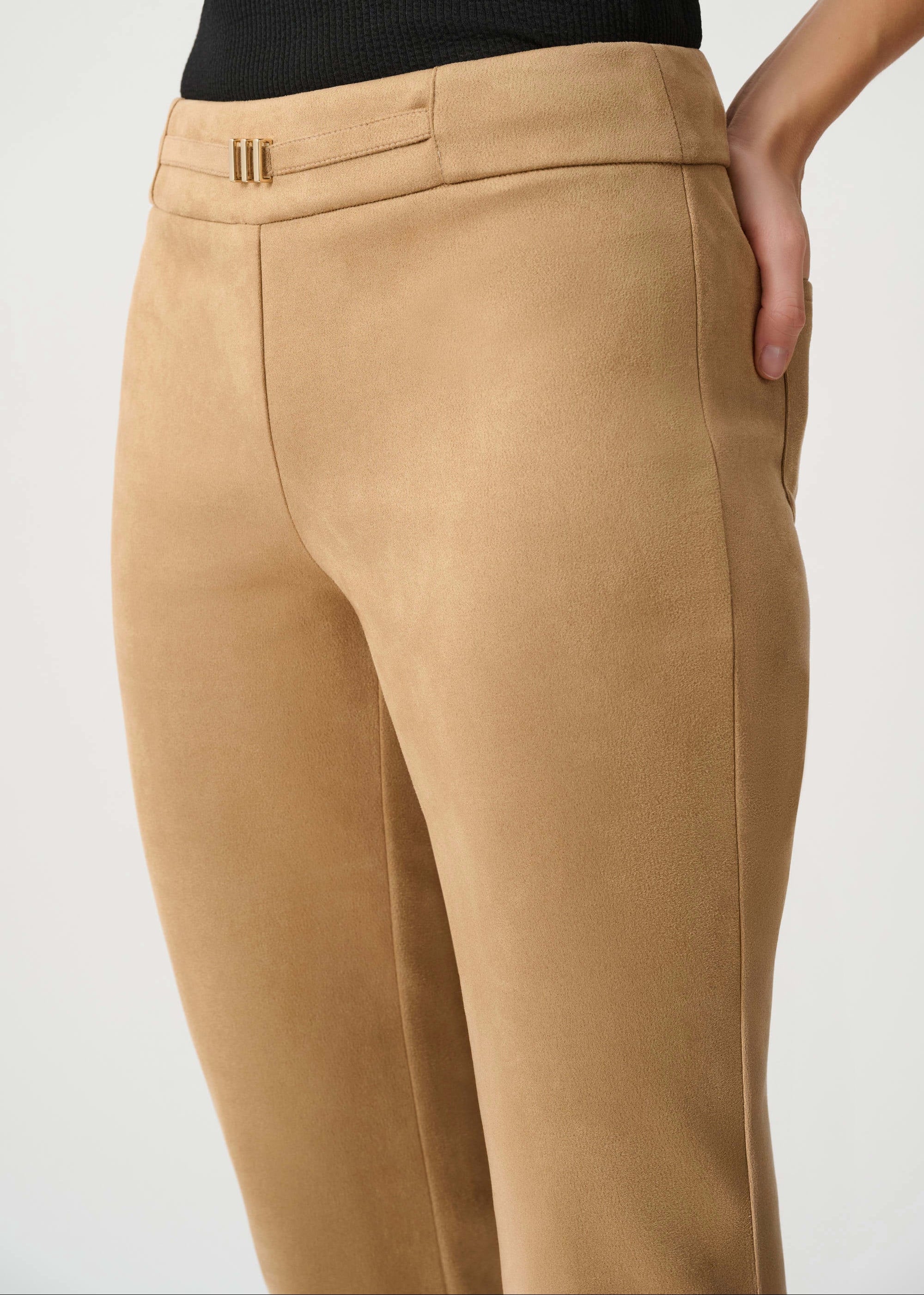 Tan pants worn by a person on a white background