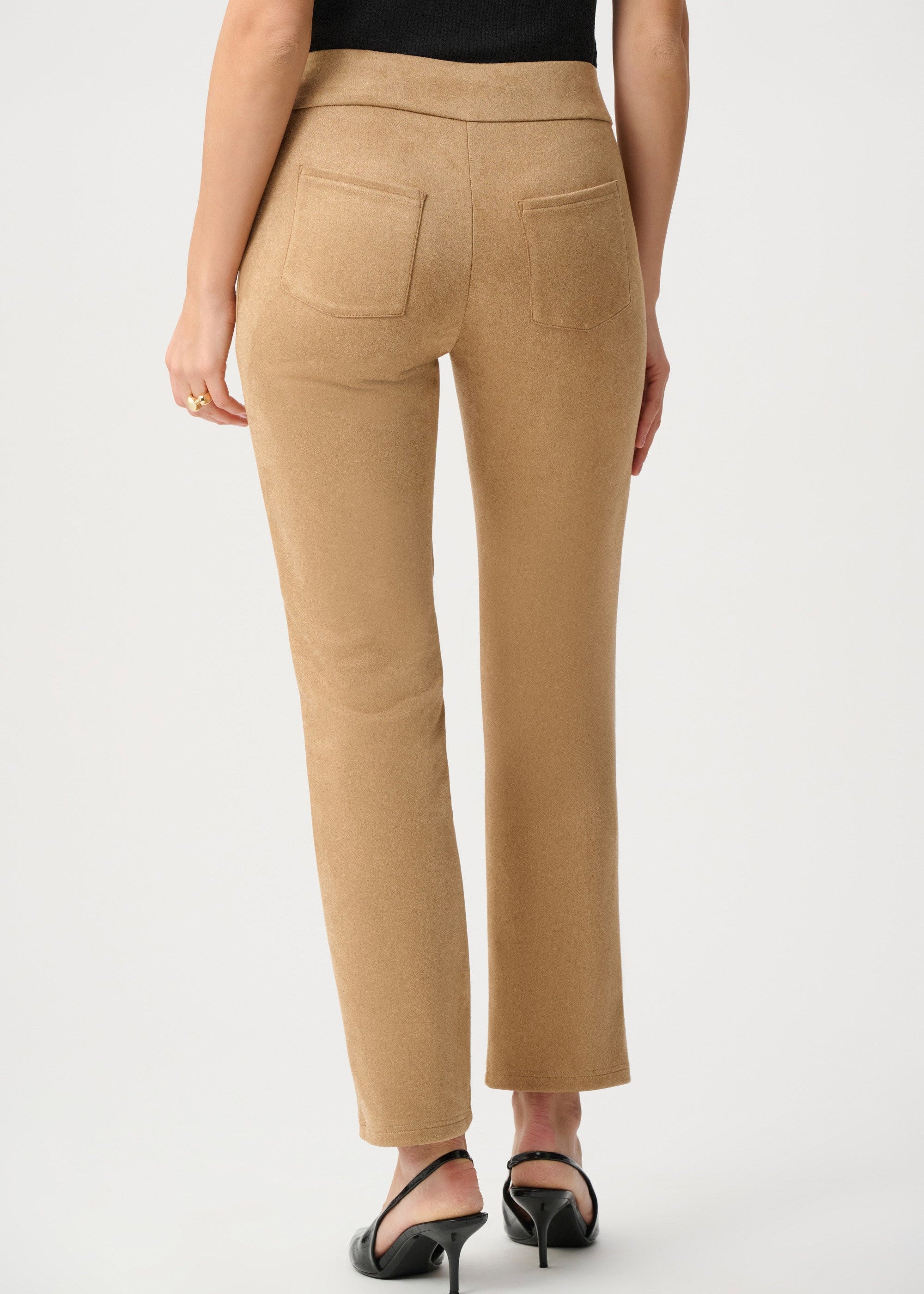 Beige pants worn by a person on a white background