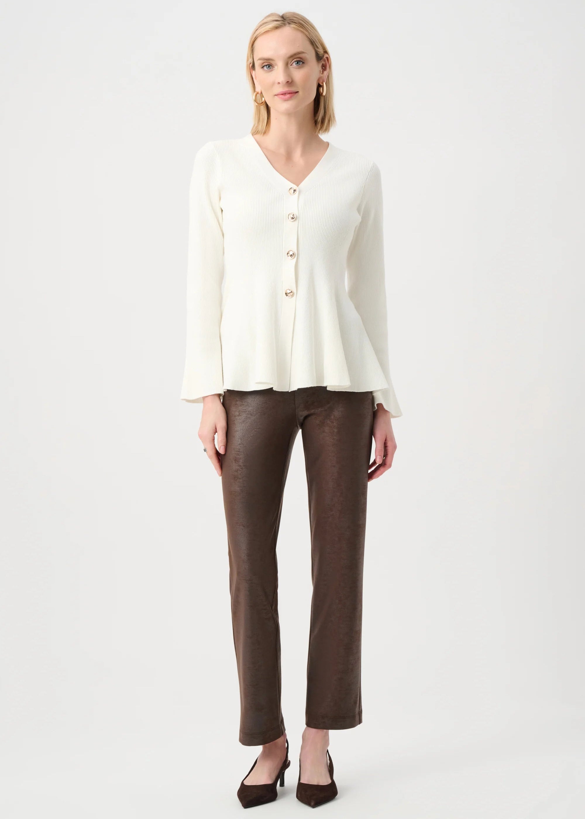Woman wearing a white blouse and brown pants on a white background