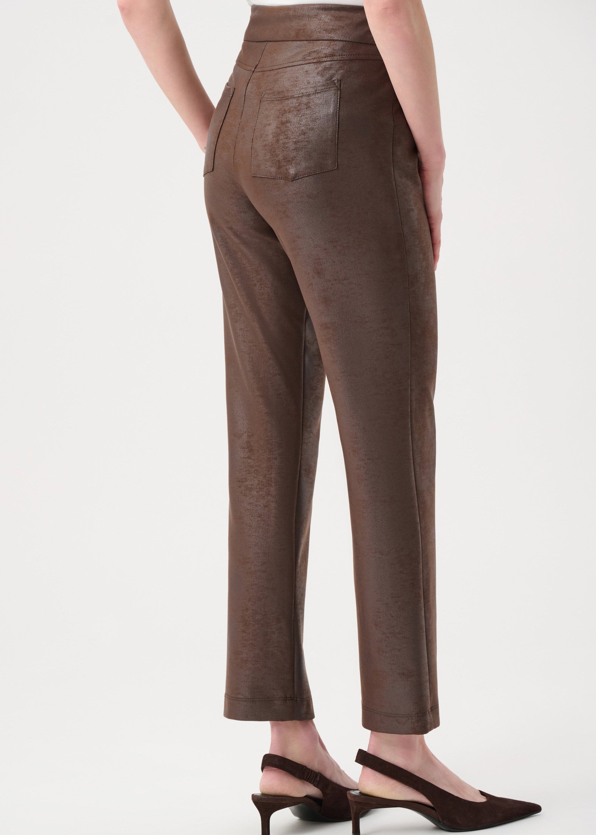 Brown pants worn by a person on a white background