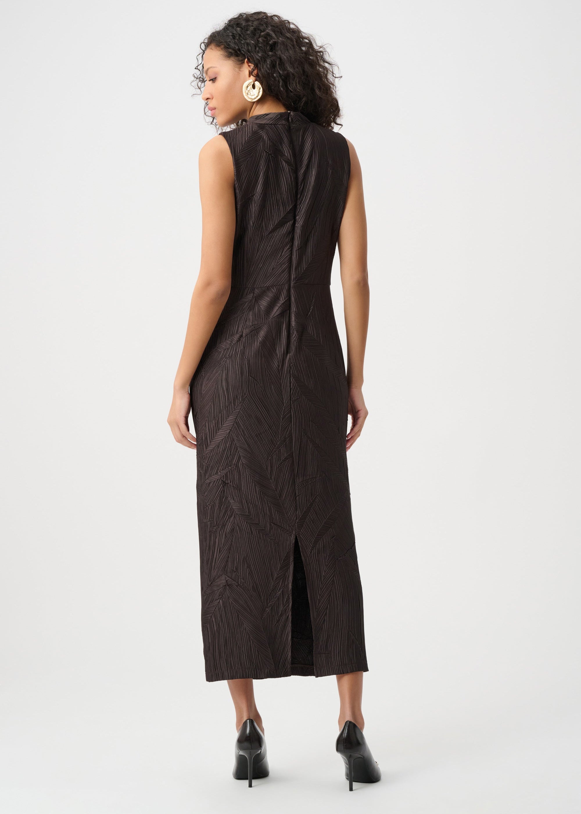 Woman wearing a black sleeveless dress on a white background