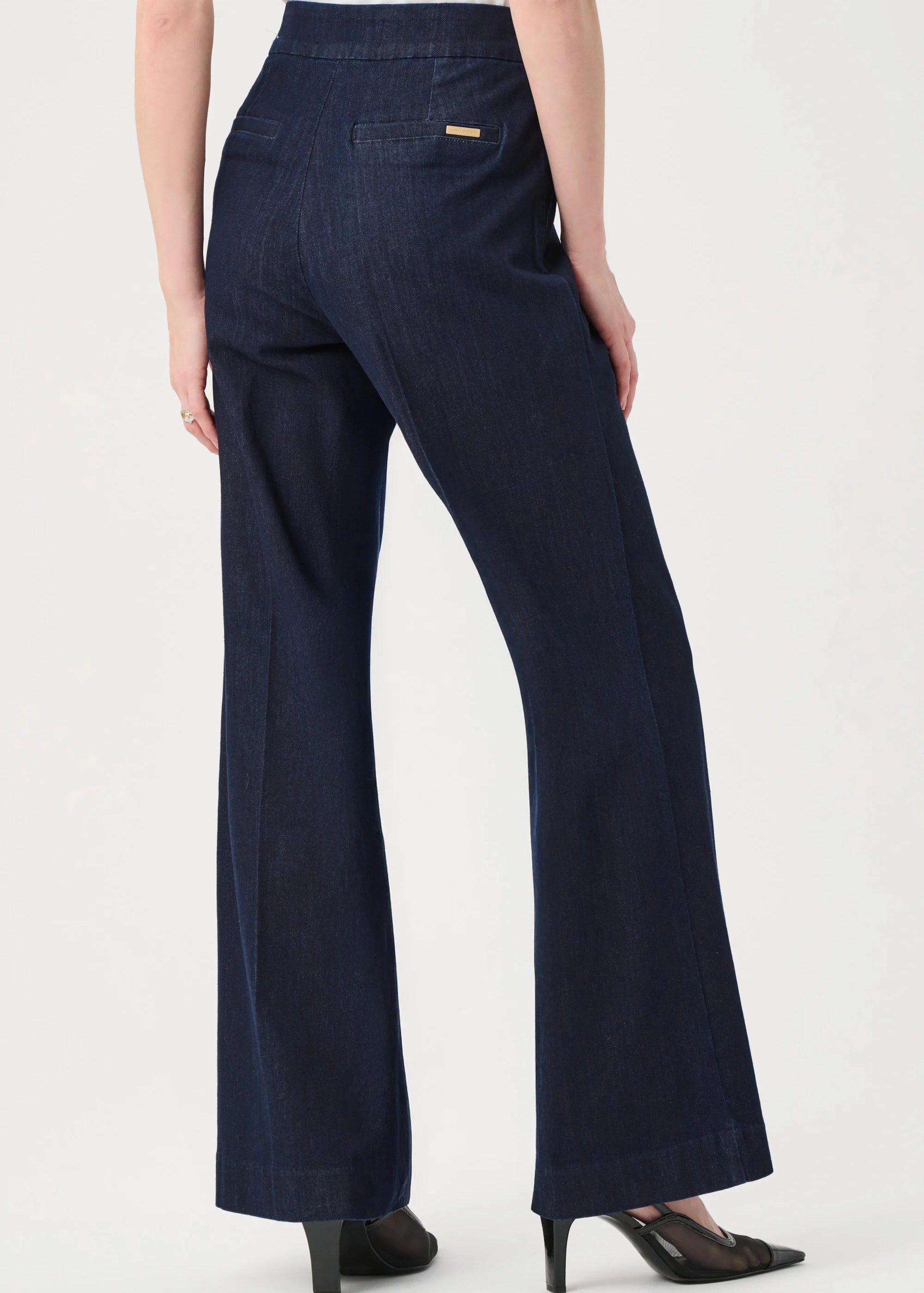 Navy blue pants worn by a person on a white background