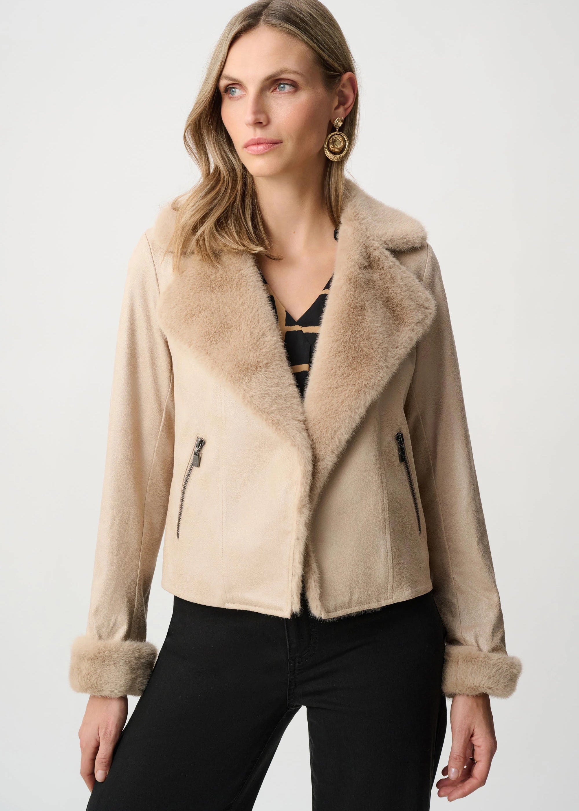Woman wearing a beige shearling jacket on a white background