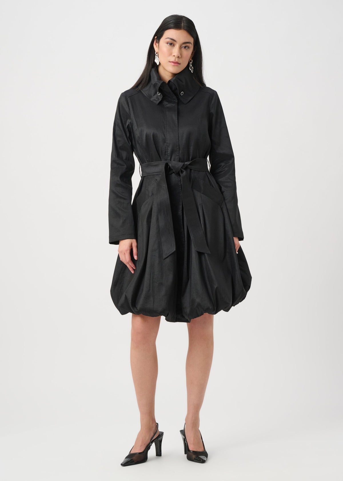 Woman wearing a black coat on a white background