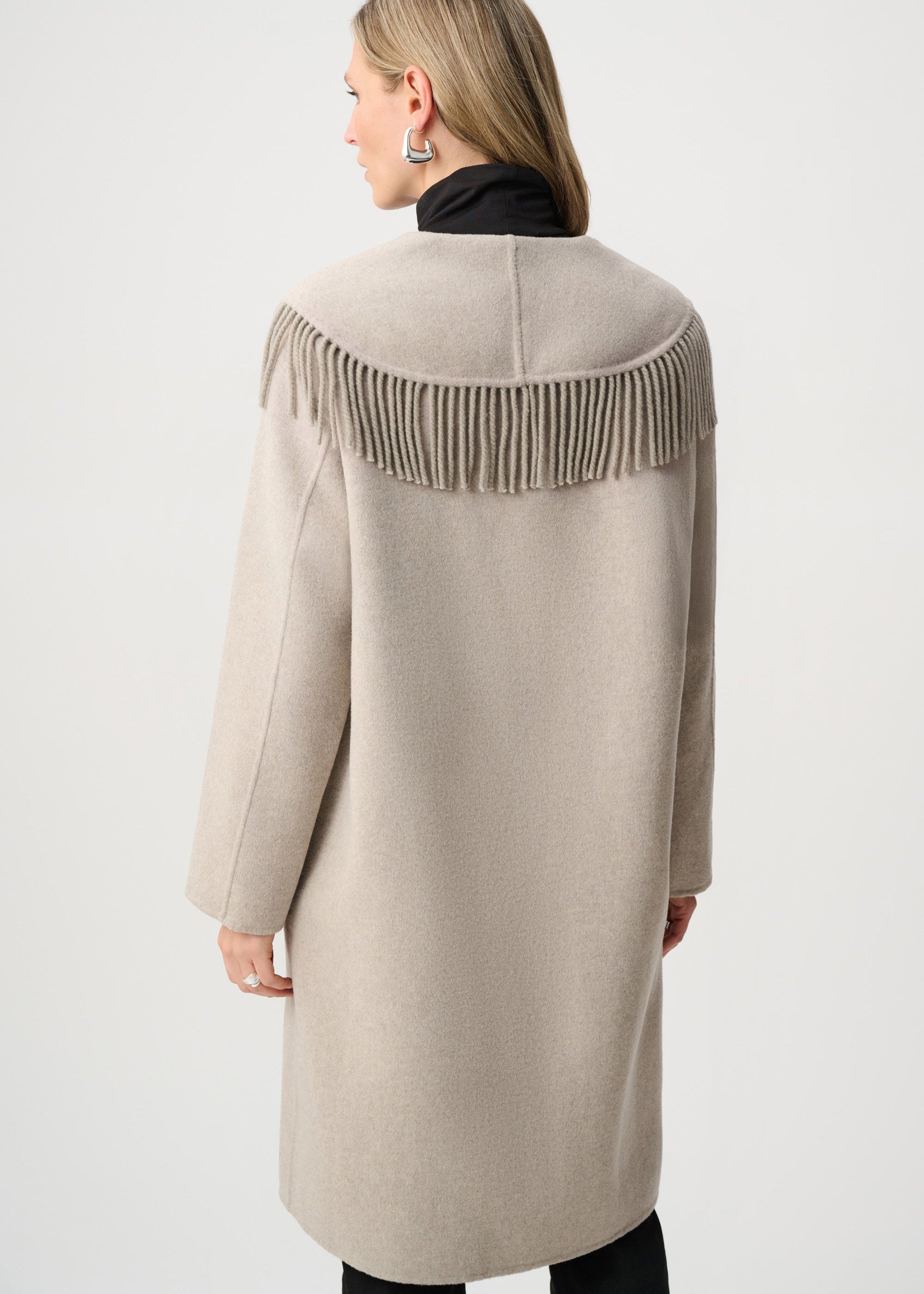 Beige coat with fringe details on a white background