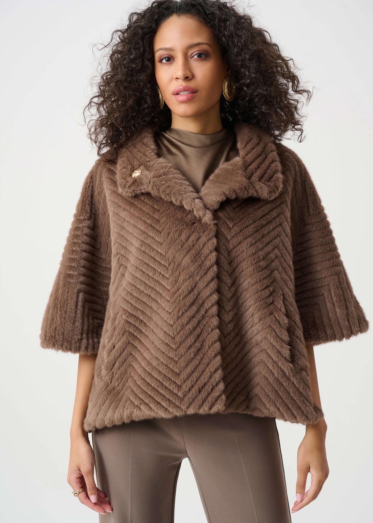 Woman wearing a brown textured jacket on a white background