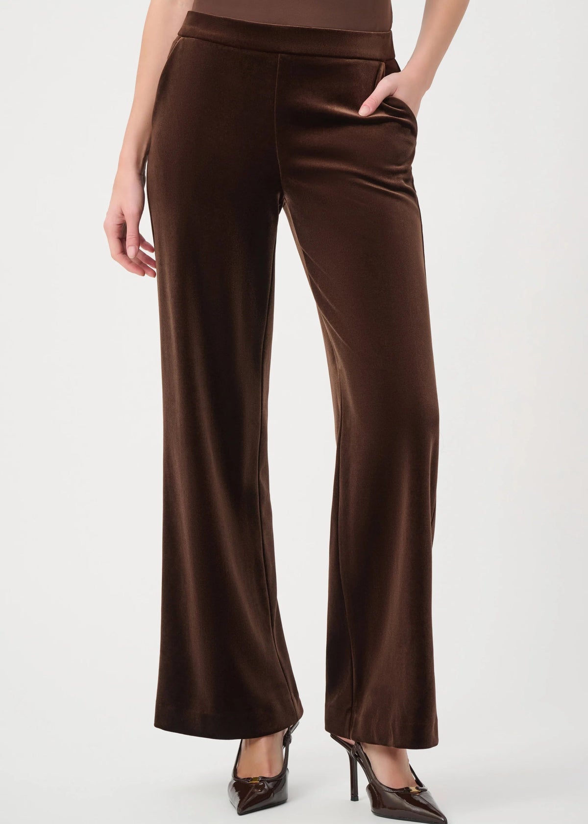 Brown pants worn by a person on a white background