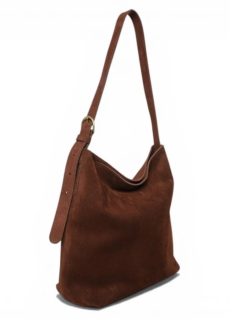 A brown suede hobo shoulder bag with a single adjustable strap and a gold-tone ring detail, shown on a plain white background.