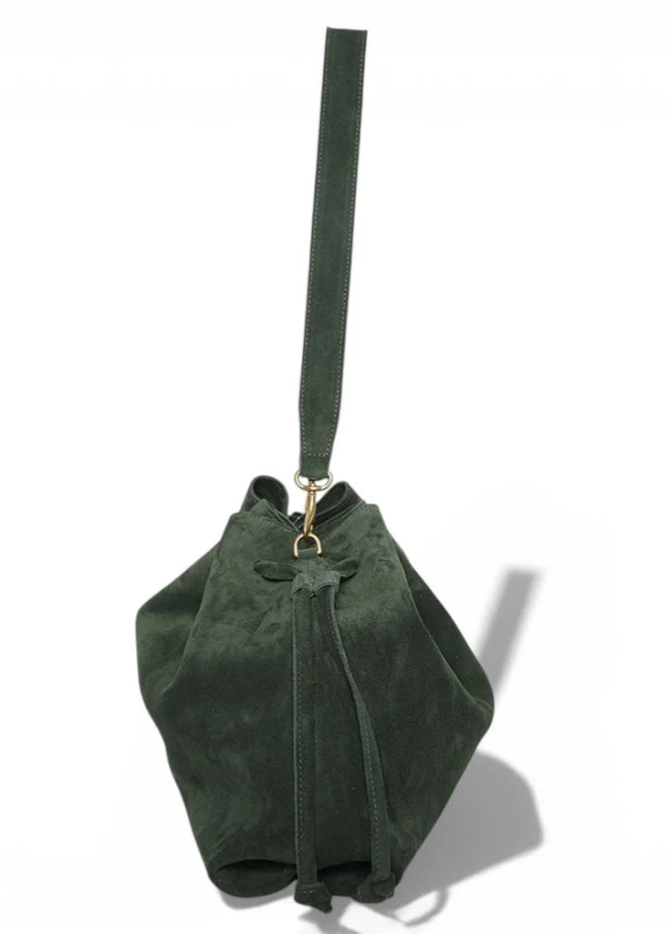 Green suede handbag with a strap on a white background