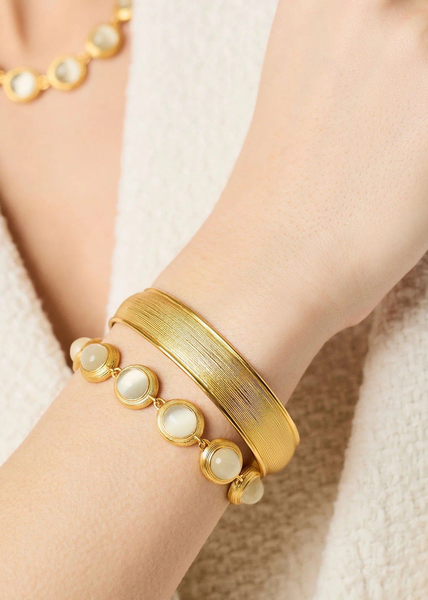 woman wearing gold plated bracelet