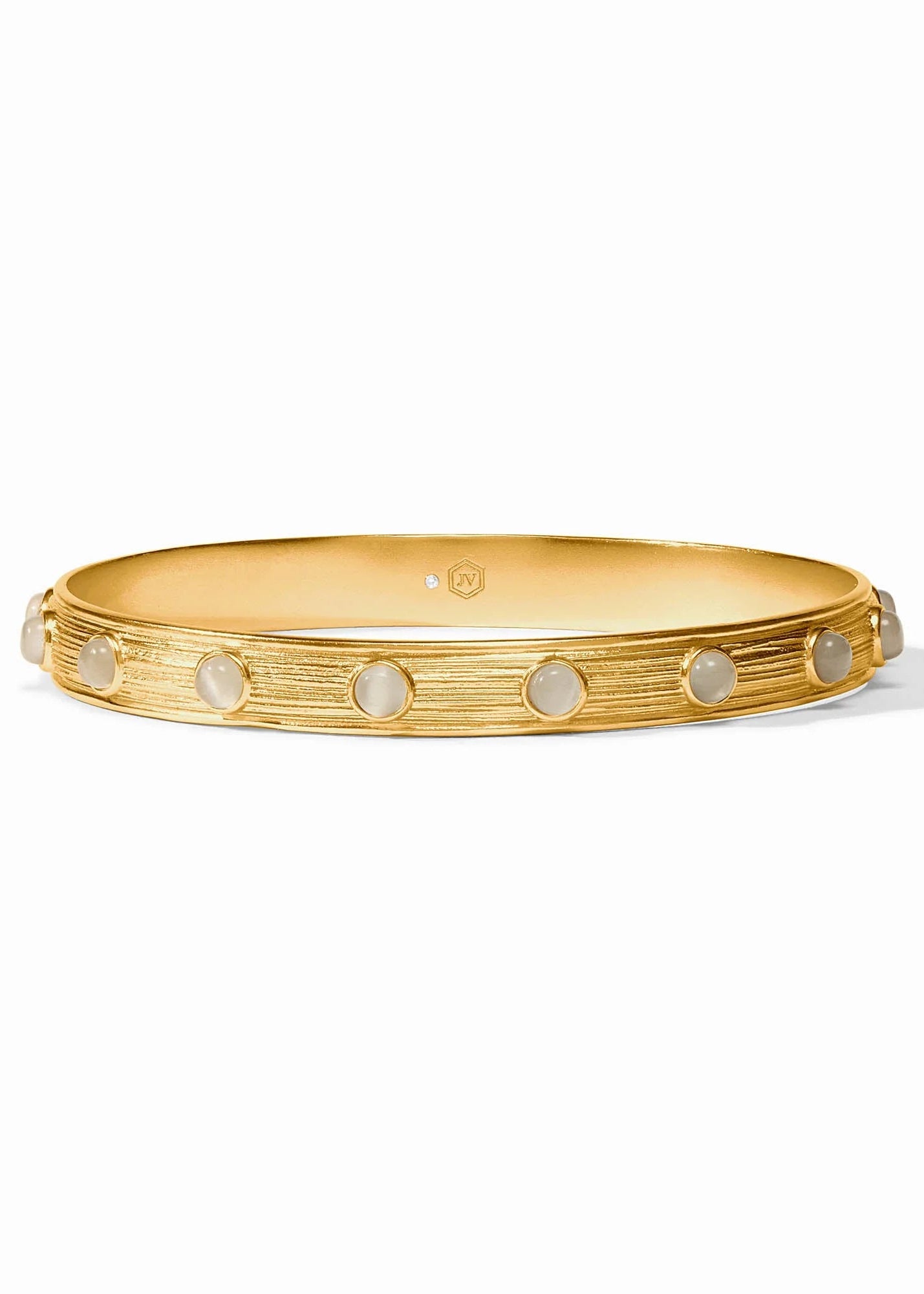 A gold bangle bracelet with a textured, brushed finish and a row of round, light-colored inlay stones, shown on a clean white background.