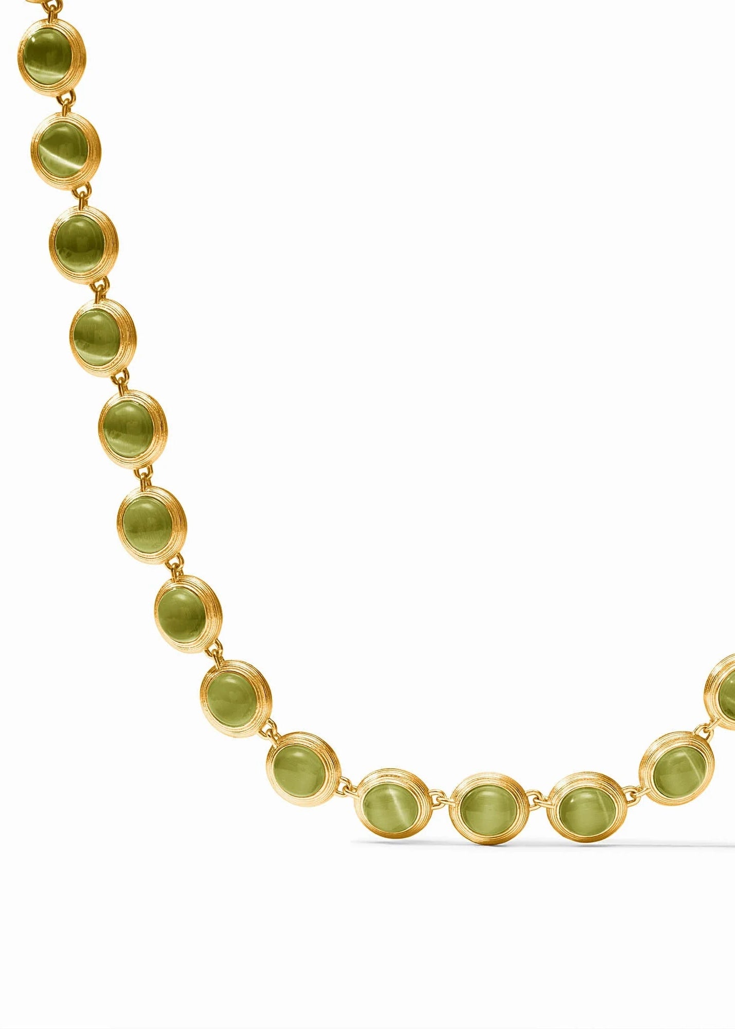 A gold chain necklace featuring round, polished olive-green cabochon gemstones, displayed on a clean white background.