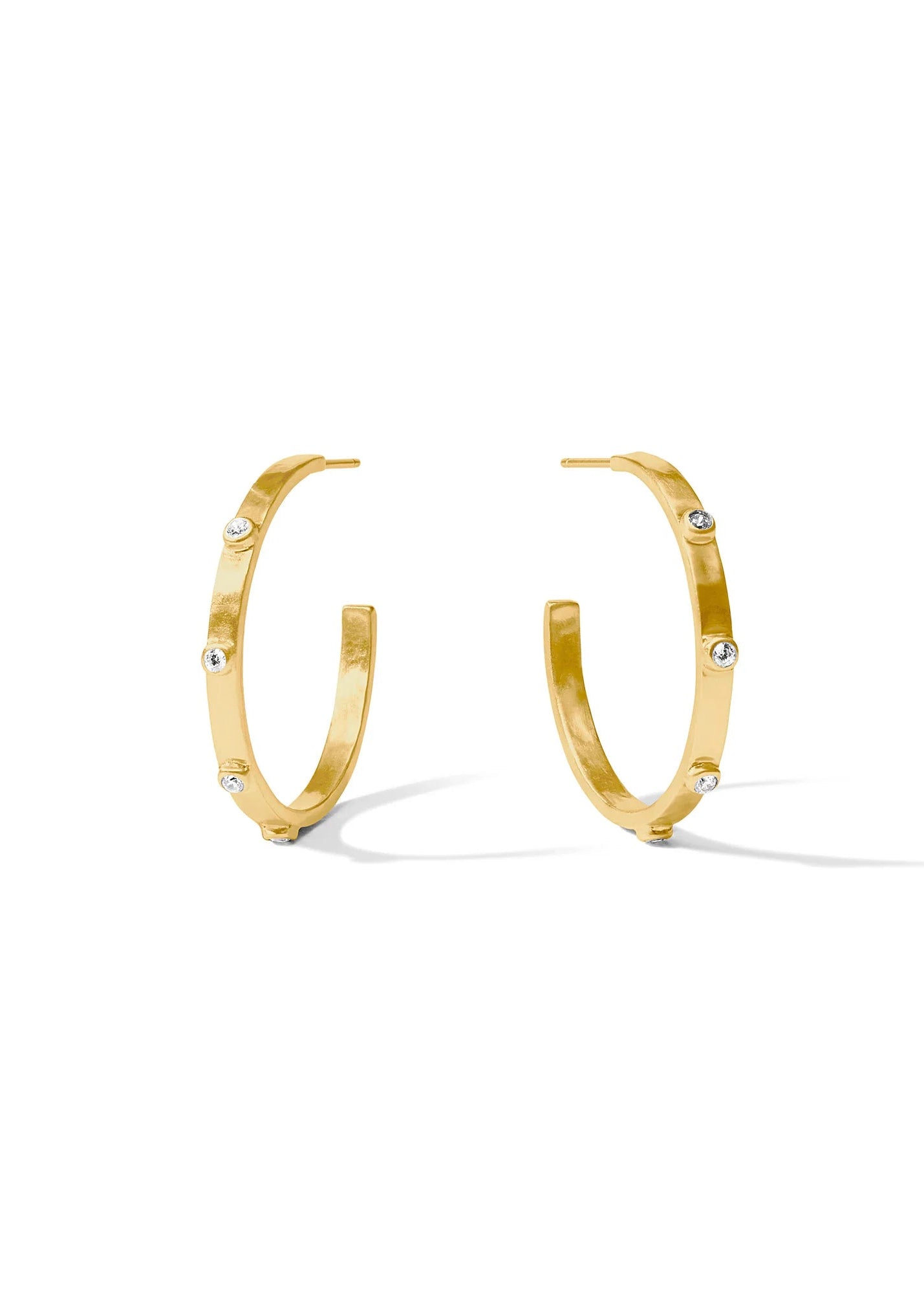 Gold hoop earrings with small stones on a white background