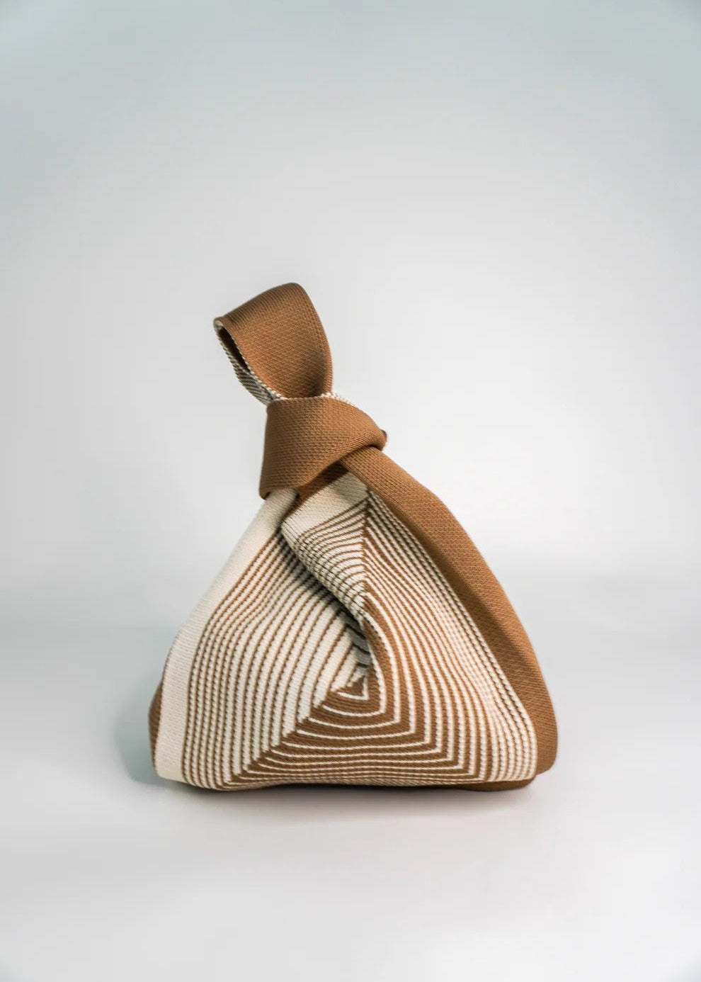 Textured bag with a geometric pattern on a light gray background