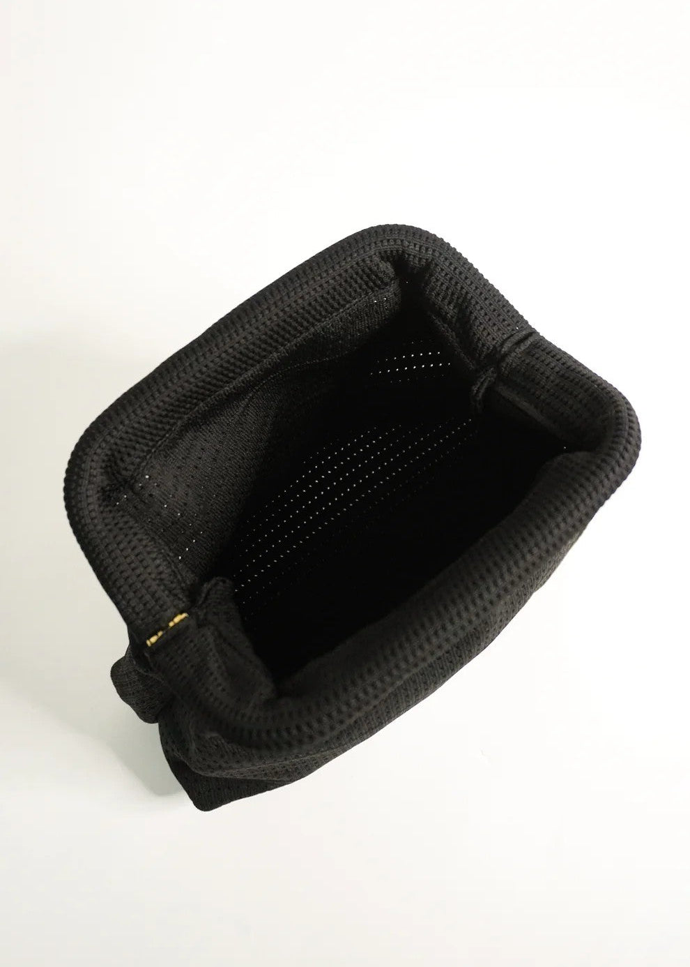 Black plastic tray with multiple small cups on a white background