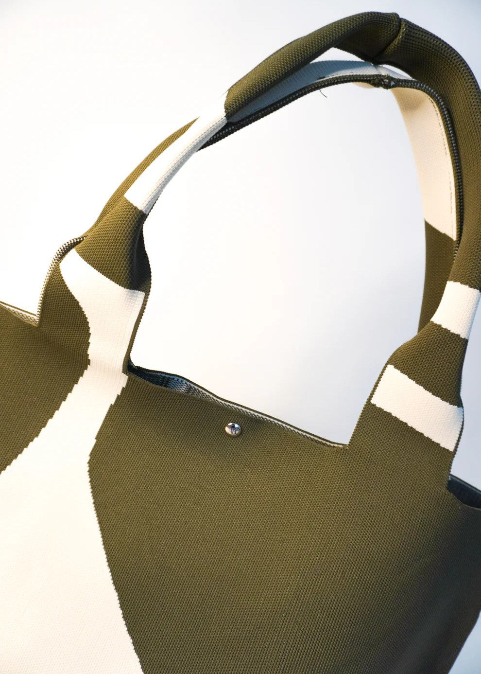 Green and white striped shirt with a collar on a light background
