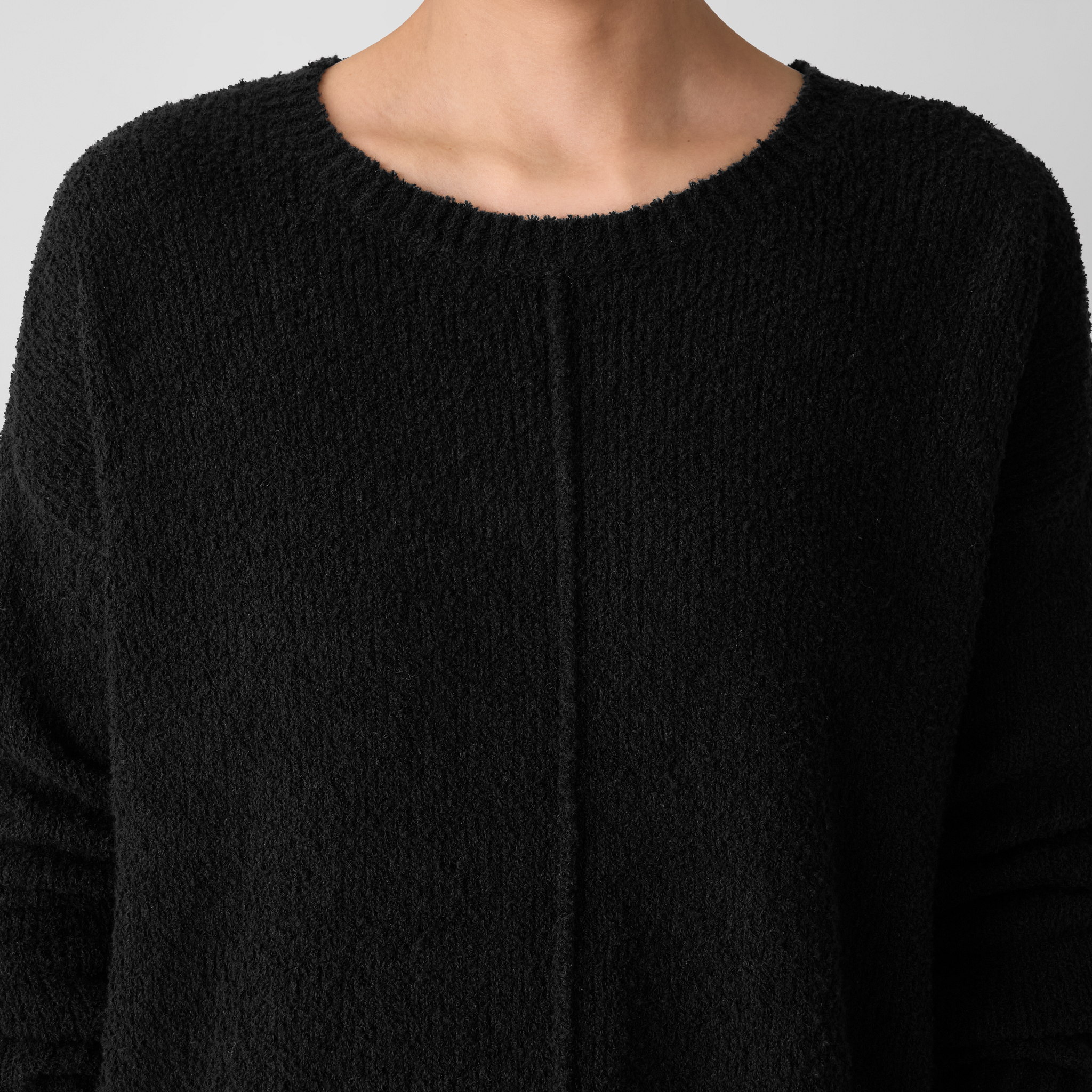 Close-up of an Eileen Fisher crewneck sweater in Woodland with a plain background