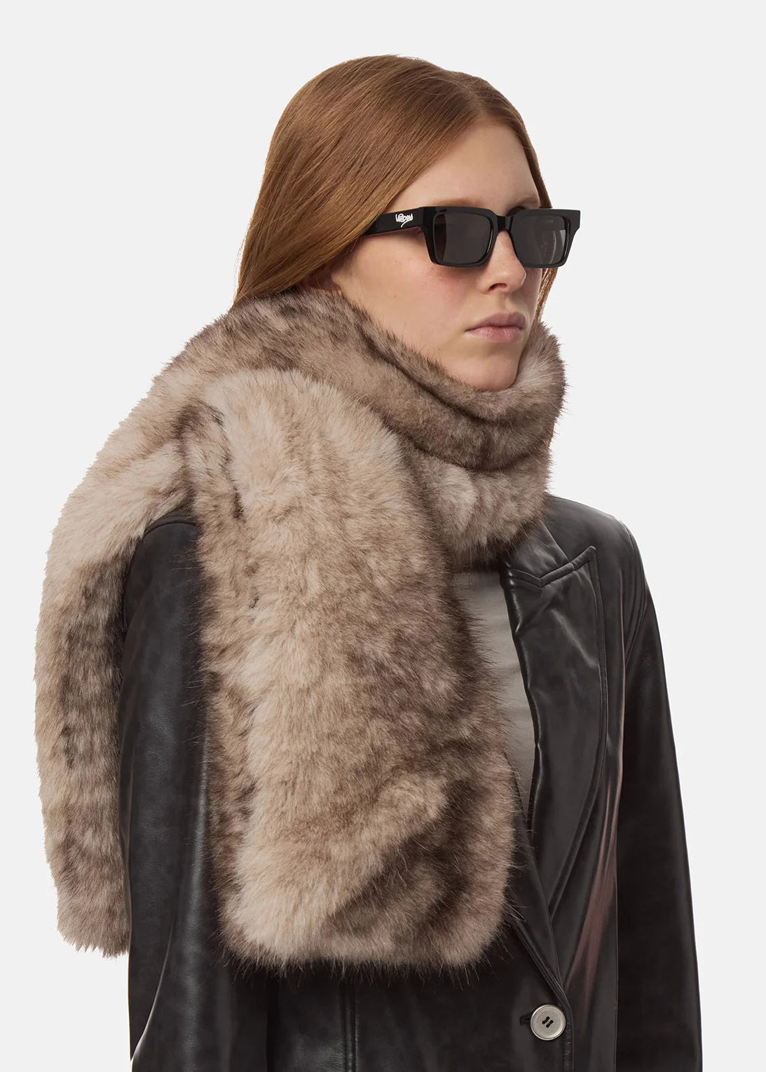 Woman wearing a fur scarf and sunglasses on a white background