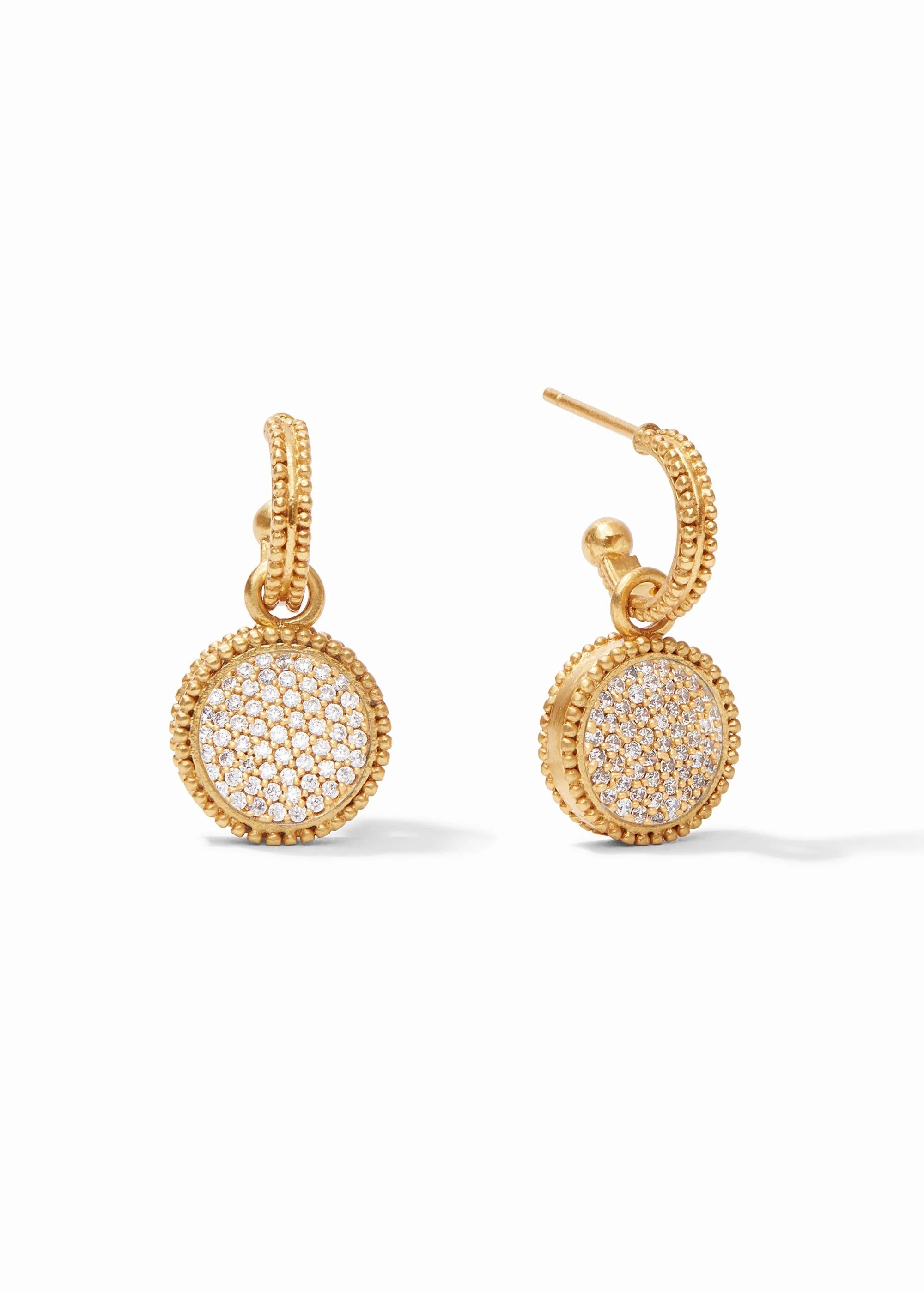 Gold earrings with circular designs on a white background