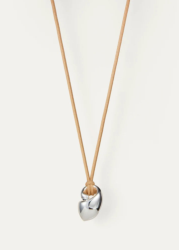 Silver pendant necklace on a light beige background