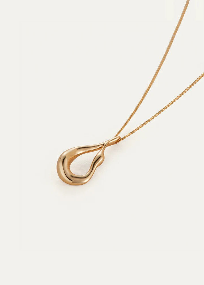 Gold teardrop pendant on a chain against a white background