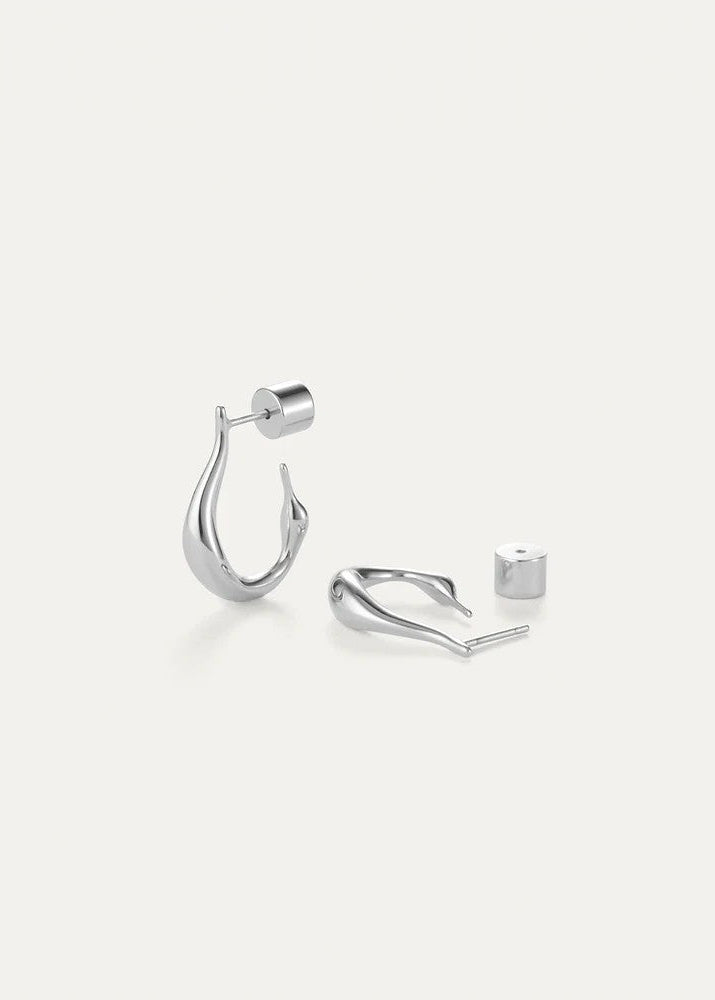A pair of polished silver huggie hoop earrings with a matching cylindrical stud backing, displayed on a clean, light off-white background.