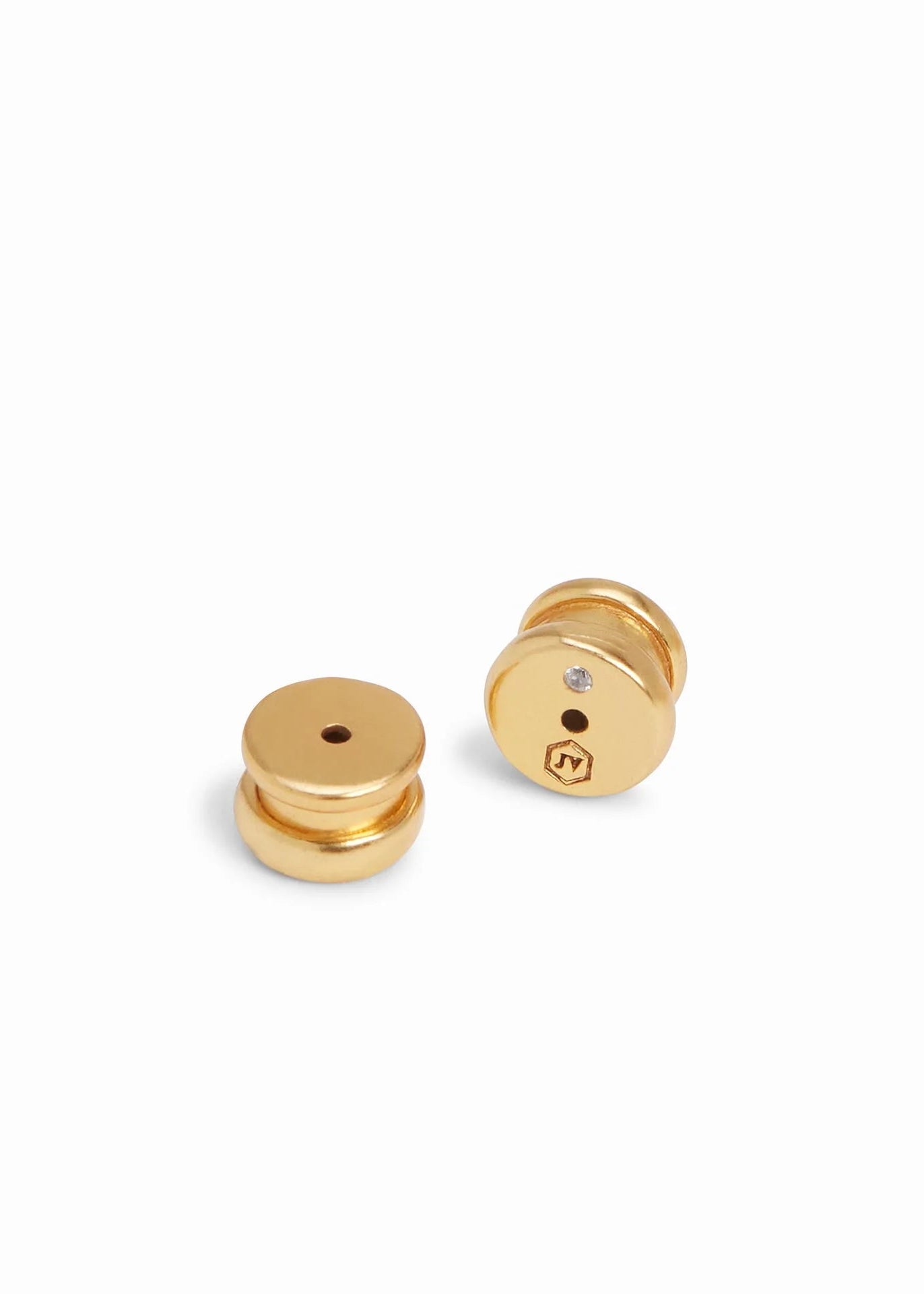 Two gold earrings on a white background