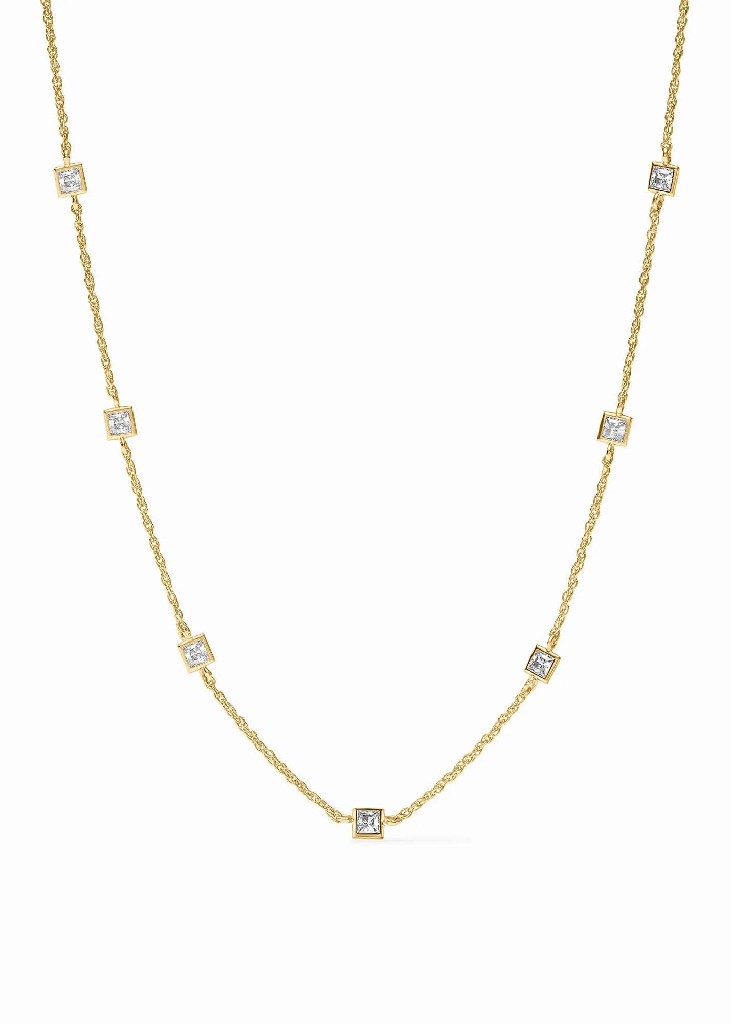 A delicate yellow gold chain necklace featuring seven small square bezel-set clear stones spaced evenly along the chain, displayed on a clean white background.