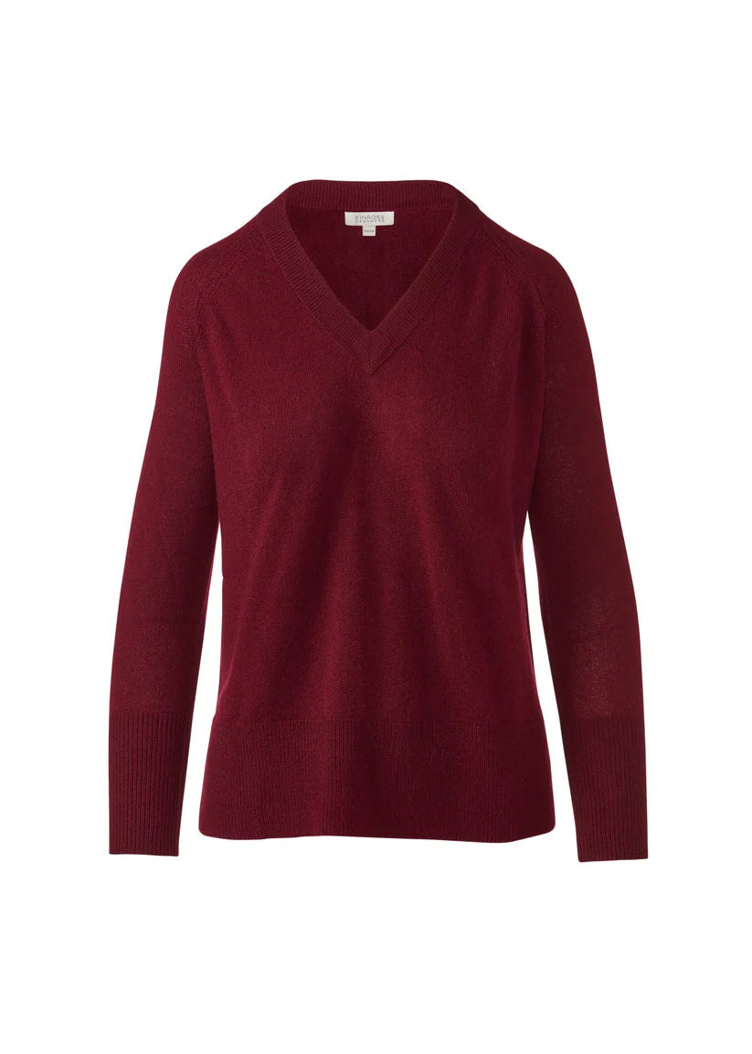 A women's long-sleeve V-neck knit sweater in a deep burgundy red, shown against a plain white background.