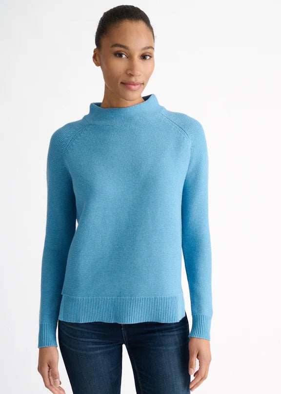 Woman wearing a blue sweater on a white background
