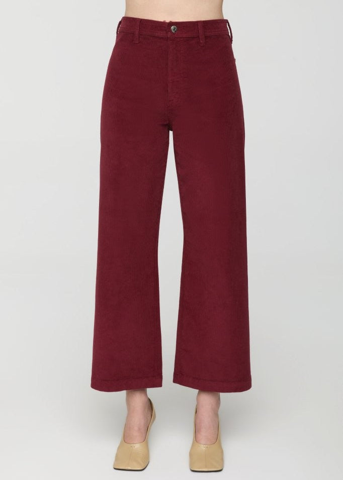 Maroon wide-leg pants worn by a person on a white background