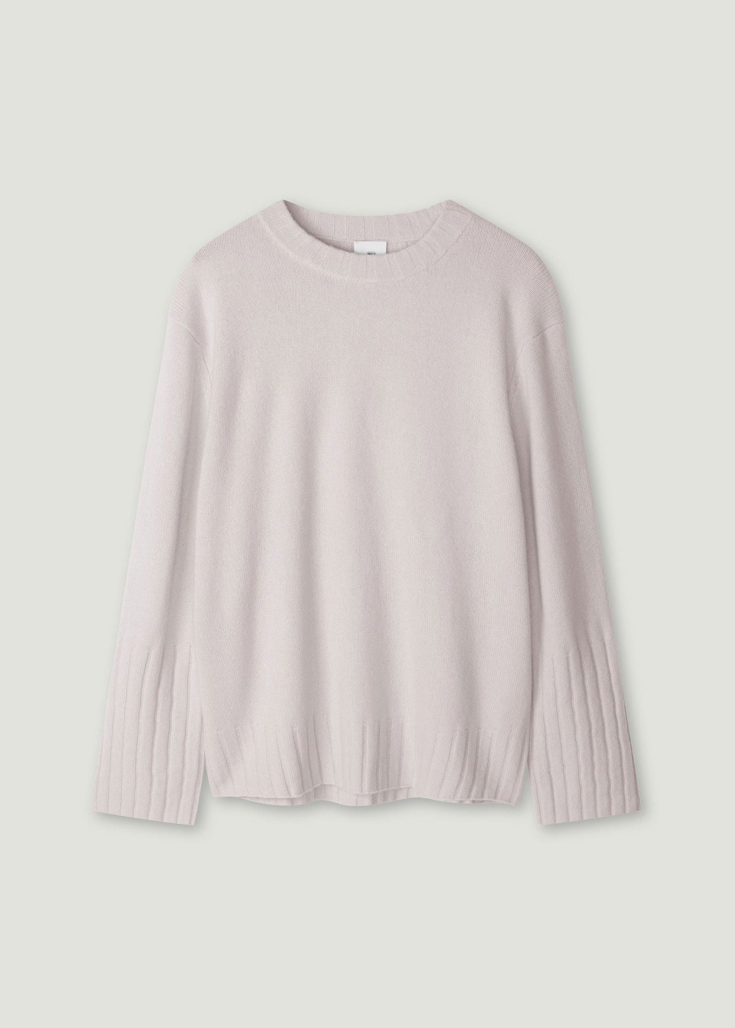 A light pink long-sleeve knit sweater with ribbed cuffs and hem, displayed flat against a light gray background.