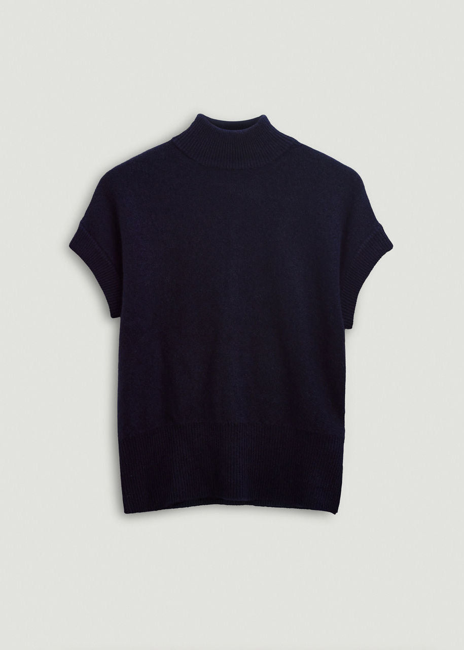 Navy turtleneck sweater on a light gray background