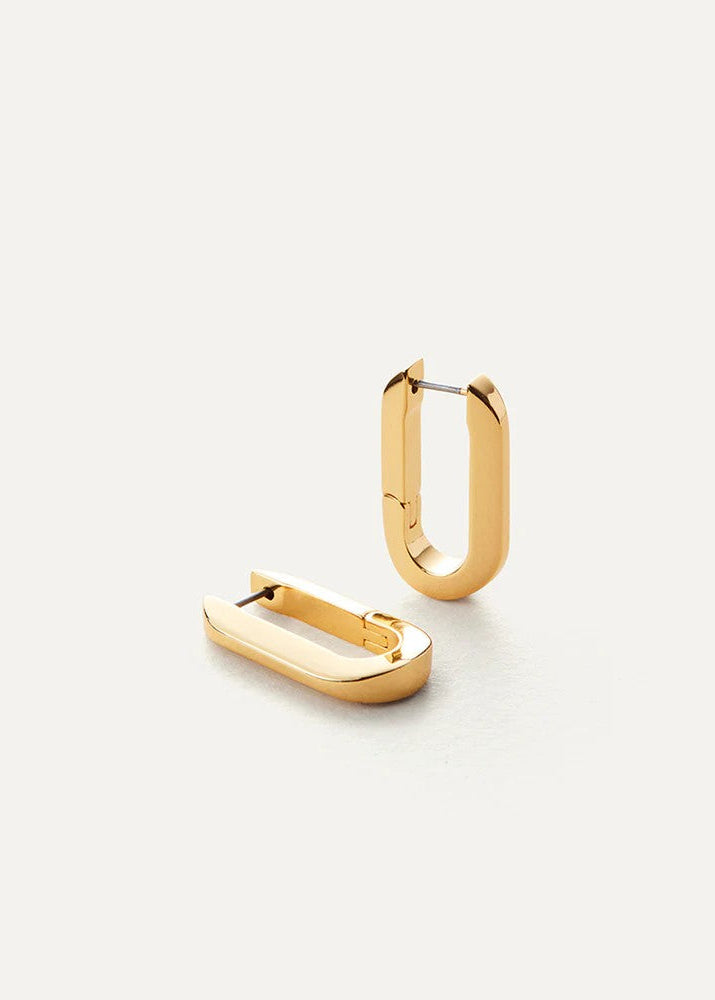 Gold hoop earrings on a light gray background