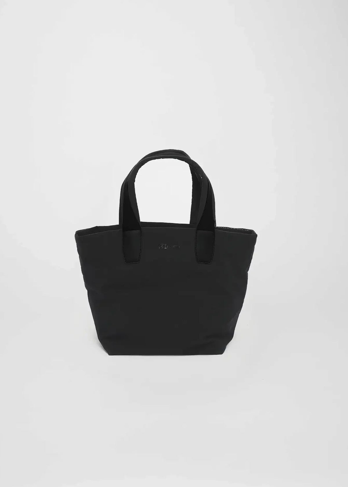 A black canvas tote bag with dual top handles, photographed against a light gray studio background.