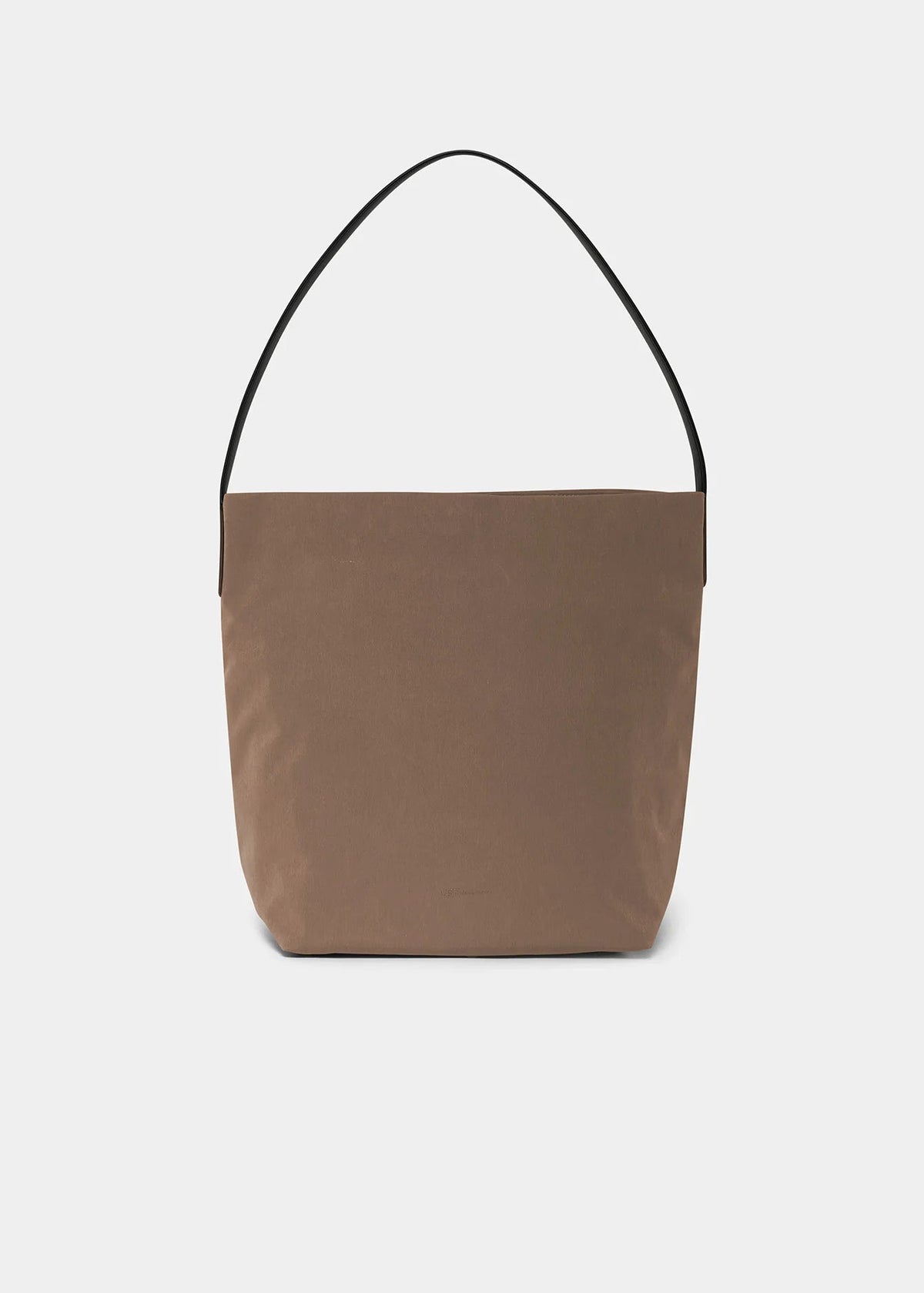 A minimalist taupe-brown canvas tote bag with a single black shoulder strap, photographed against a clean, light gray background.