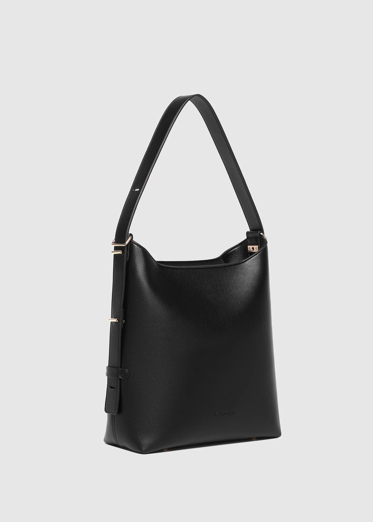 Black handbag with a strap on a light gray background