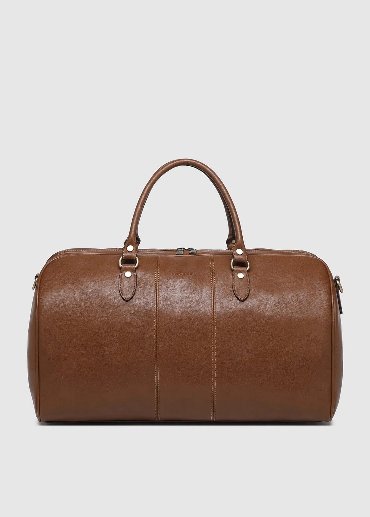 A brown leather duffel bag with dual top handles and gold-tone hardware, photographed against a solid light gray background.