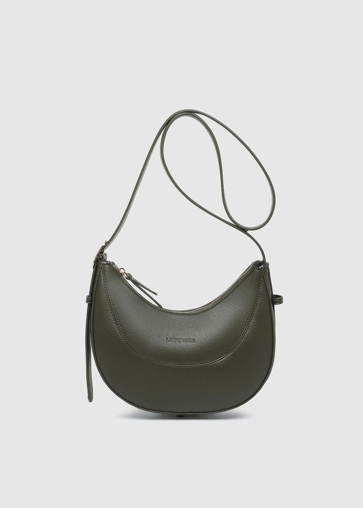 Green handbag with a strap on a light gray background